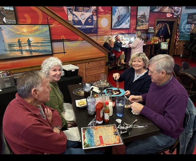 Friends sharing a laugh around their game-night table