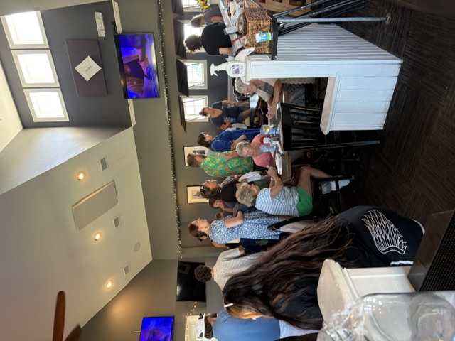 A lively gathering with guests seated and standing around tables