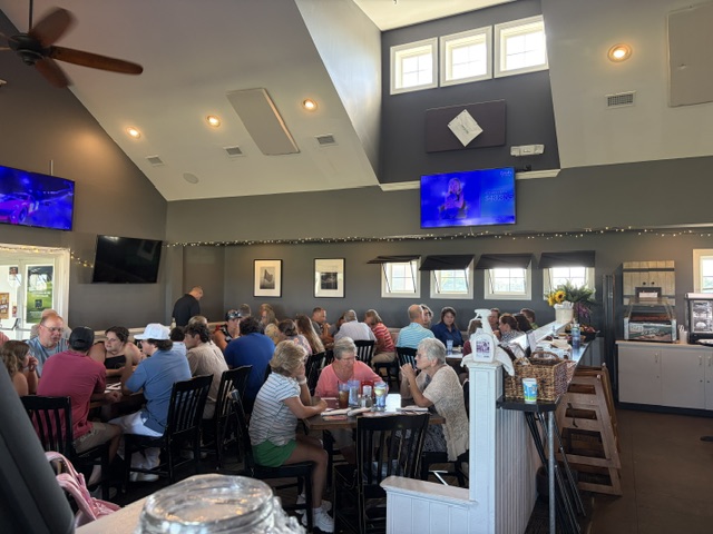 Guests gathered around tables in a local venue